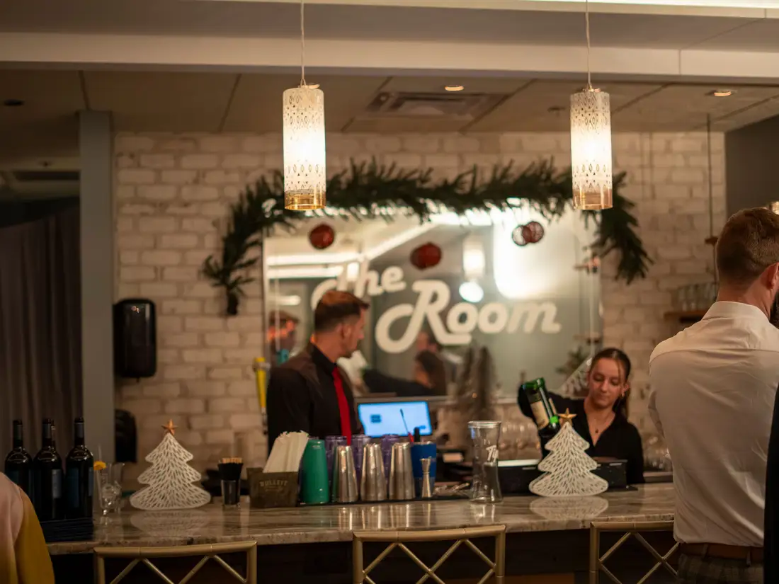 Bartenders preparing drinks for guests in The Room—the private event space at JohnnyLukes.