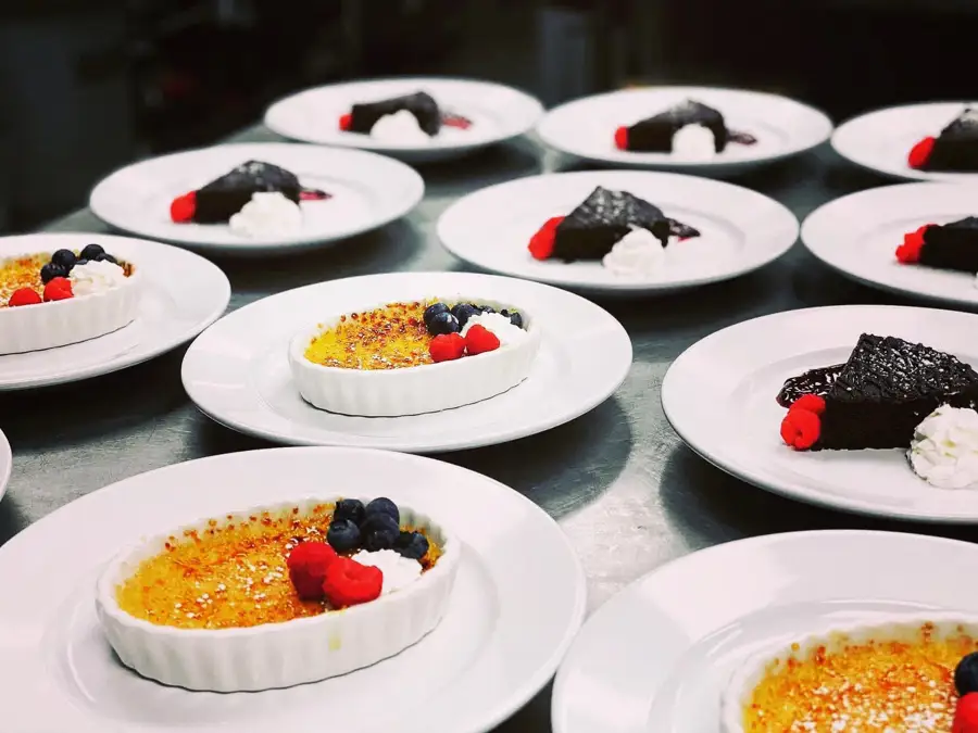 Desserts being prepared for a large group event.